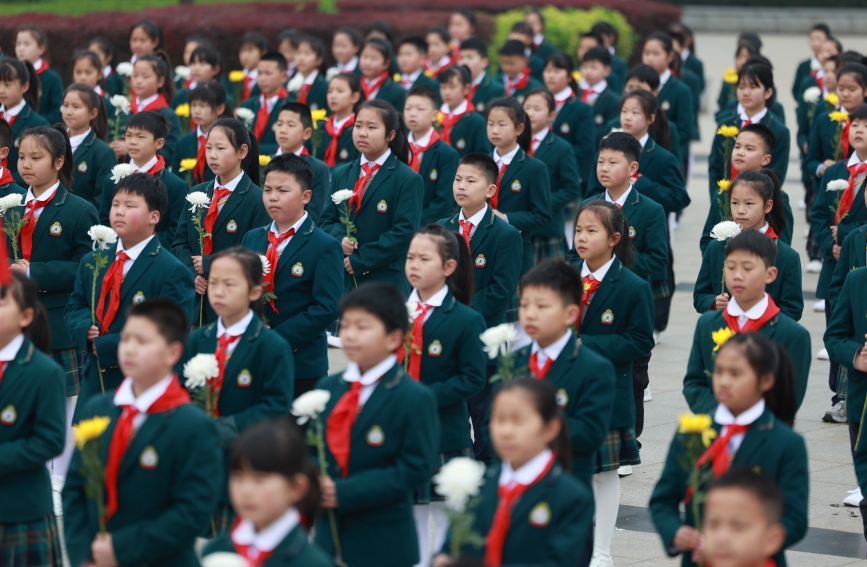 少先队员在烈士纪念碑前默哀。人民网记者 郭婷婷摄