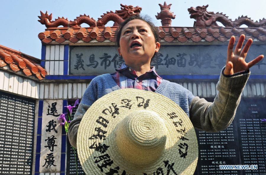 Wang Xuan, leader of a Chinese plaintiff group seeking compensation from the Japanese government for damages stemming from the use of germ warfare during Japan's aggression war on China, adresses a mourning activity in Chongshan Village of Yiwu City, east China's Zhejiang Province, April 5, 2014.