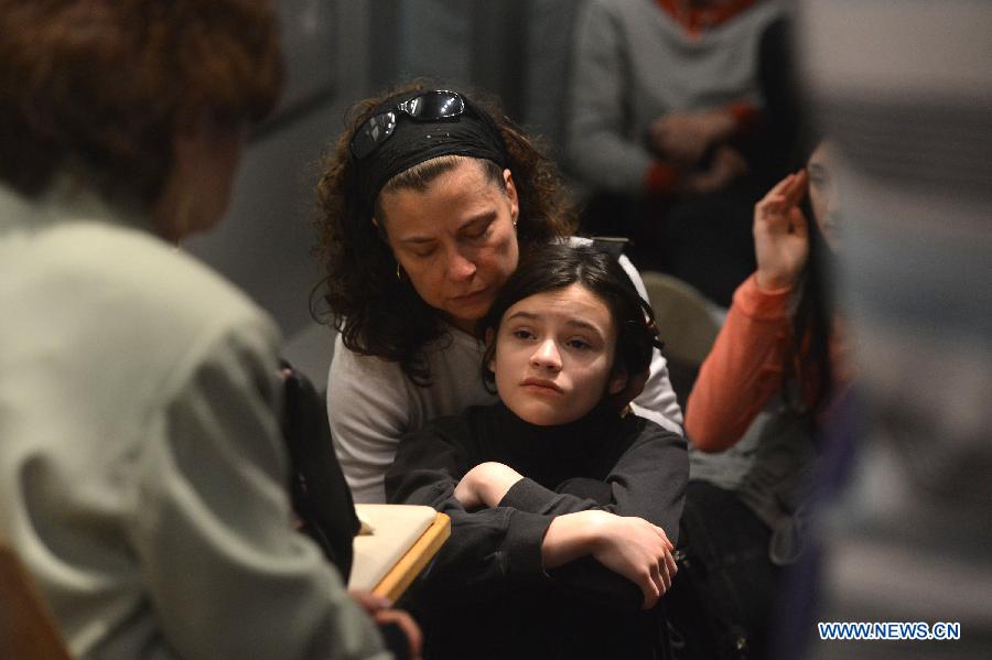 A woman and her daughter listen to a Holocaust survivor in the Museum of Jewish Heritage in New York City, the United States, on April 28, 2014. An event named 'A Living Memorial to the Holocaust' is held here for commemoration of Holocaust Remembrance Day on Monday. Holocaust survivors from Poland, Germany, and Belgium who are now living in New York met with more than 300 students and visitorsg here and shared with them what they had been thourgh during the Holocaust. (Xinhua/Wang Lei) 