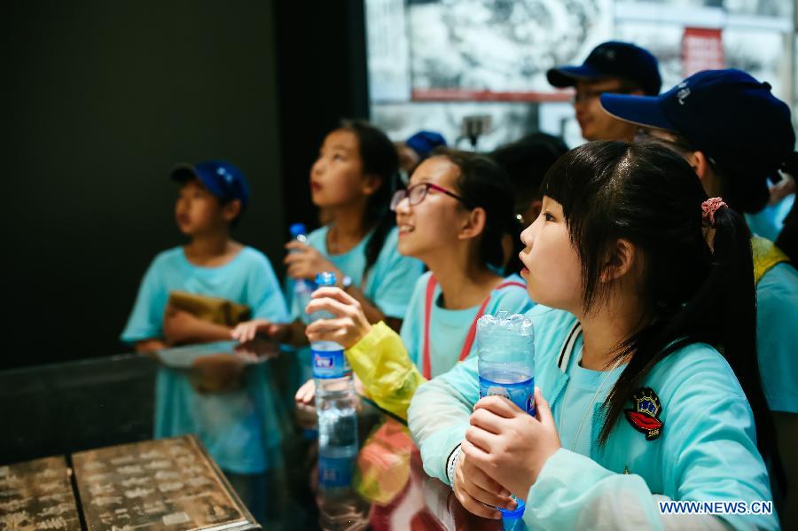 Children visit the 'Great Victory, Historic Contribution' exhibition in Beijing, capital of China, July 14, 2015.