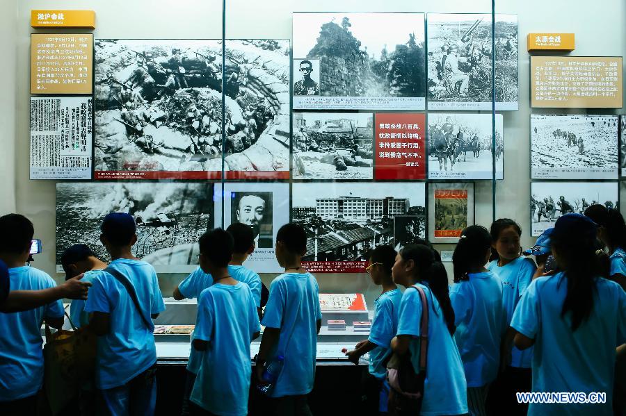 Children visit the 'Great Victory, Historic Contribution' exhibition in Beijing, capital of China, July 14, 2015. 