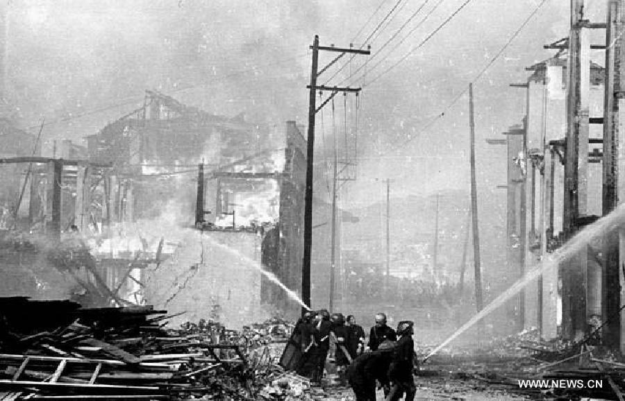 File photo shows people trying to put out fire after air-strikes carried out by Japanese army in southwest China's Chongqing, June 7, 1941. 