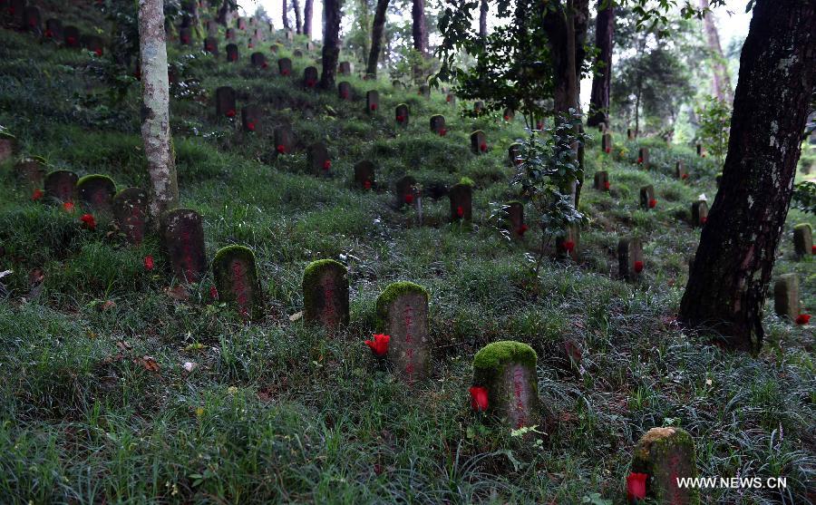 Photo taken on July 21, 2015 shows the tombs of deceased soldiers of the Chinese Expeditionary Force who died while fighting the Japanese army in World War II in Myanmar, at a martyrs' cemetery in Tengchong, a border town in southwest China's Yunnan Province.