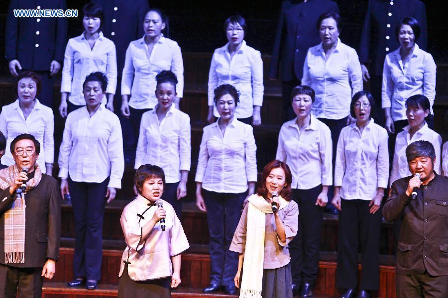 Performers sing chorus during an evening concert to commemorate the 70th anniversary of the victory in the Chinese People's War of Resistance against Japanese Aggression and the victory of World's Anti-Fascist War, in town hall of Sydney, Australia, July 26, 2015. 