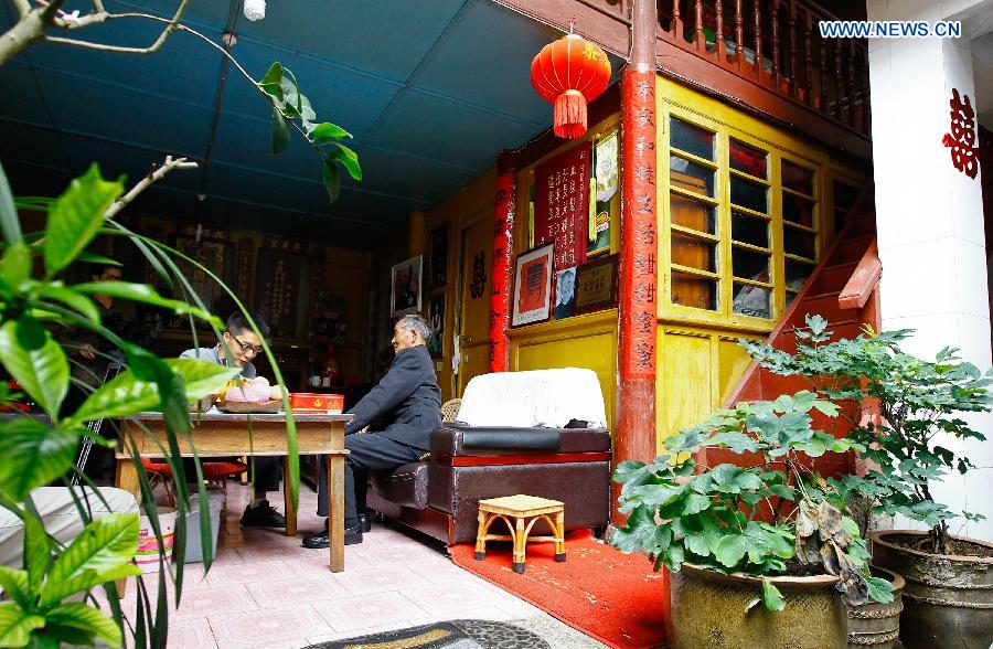 Lu Caiwen receives an interview at home in Tengchong, southwest China's Yunnan Province, July 20, 2015.