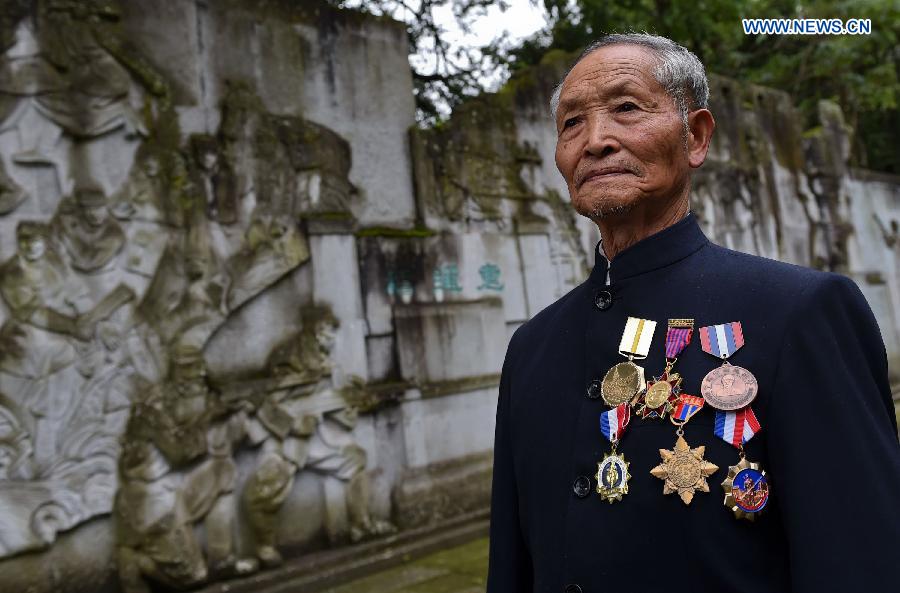 Lu Caiwen mourns for the soldiers sacrificed during the battle against Japan's invasion in Tengchong, southwest China's Yunnan Province, July 21, 2015. 