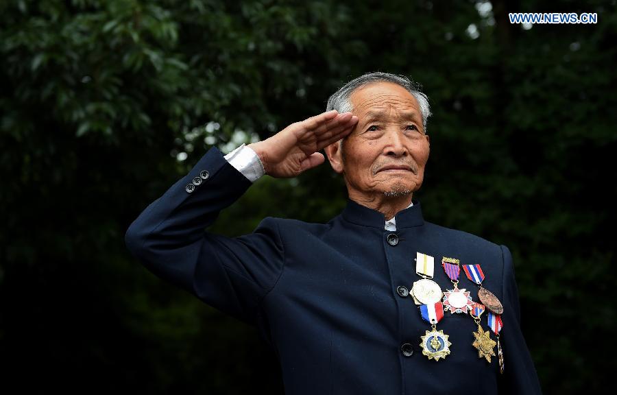 Lu Caiwen mourns for the soldiers sacrificed during the battle against Japan's invasion in Tengchong, southwest China's Yunnan Province, July 21, 2015.