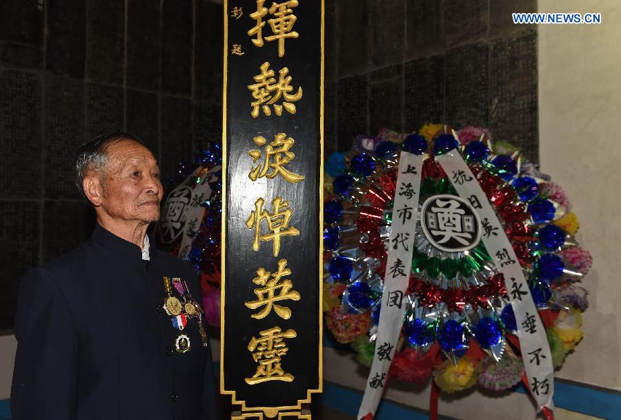 Lu Caiwen mourns for the soldiers sacrificed during the battle against Japan's invasion in Tengchong, southwest China's Yunnan Province, July 21, 2015. 