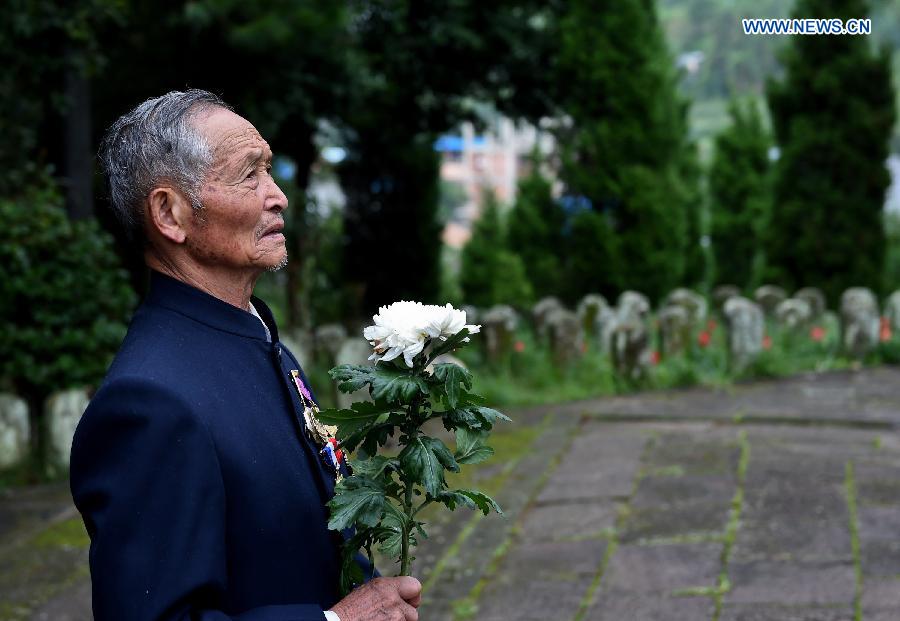 Lu Caiwen mourns for the soldiers sacrificed during the battle against Japan's invasion in Tengchong, southwest China's Yunnan Province, July 21, 2015.