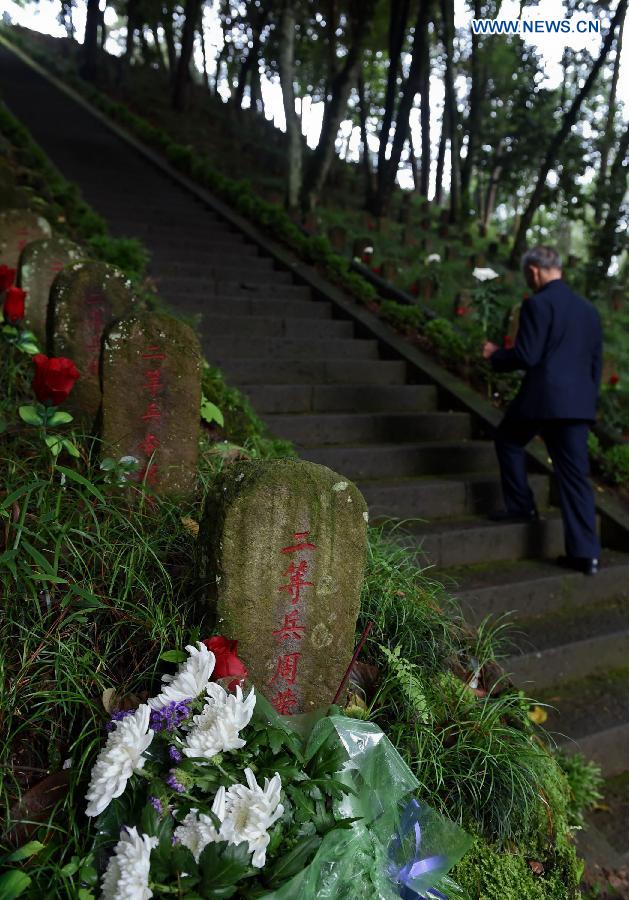 Lu Caiwen mourns for the soldiers sacrificed during the battle against Japan's invasion in Tengchong, southwest China's Yunnan Province, July 21, 2015. 