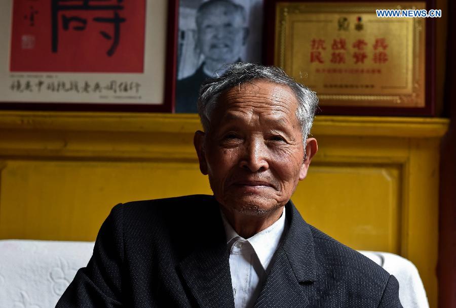 Lu Caiwen poses for a photo at home in Tengchong, southwest China's Yunnan Province, July 20, 2015.