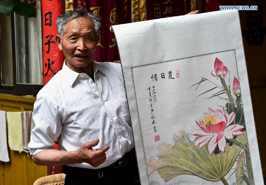 Lu Caiwen practises calligraphy at his home in Tengchong, southwest China's Yunnan Province, July 20, 2015.