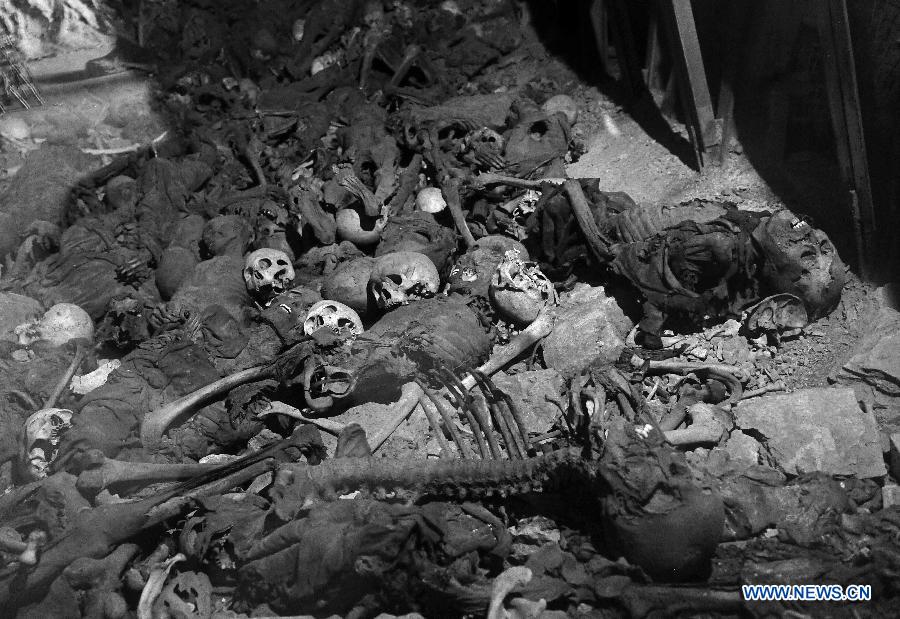 File photo taken on July 9, 2015 shows a coal mine pit cramed with skulls and bones of Chinese forced miners working for Japan during the World War II, at a memorial in Datong, north China's Shanxi Province. Japan invaded northeast China in 1931 and conducted a full-scale invasion in 1937. By the end of World War II, millions of Chinese forced laborers had been enslaved by Japanese invaders to toil under harsh conditions at mines and factories in northeast China and Japan. Those laborers were under close watch and suffered inhumane treatment. Many of them died from malnutrition, illness, physical abuse and plain murder. (Xinhua/Zhan Yan) 