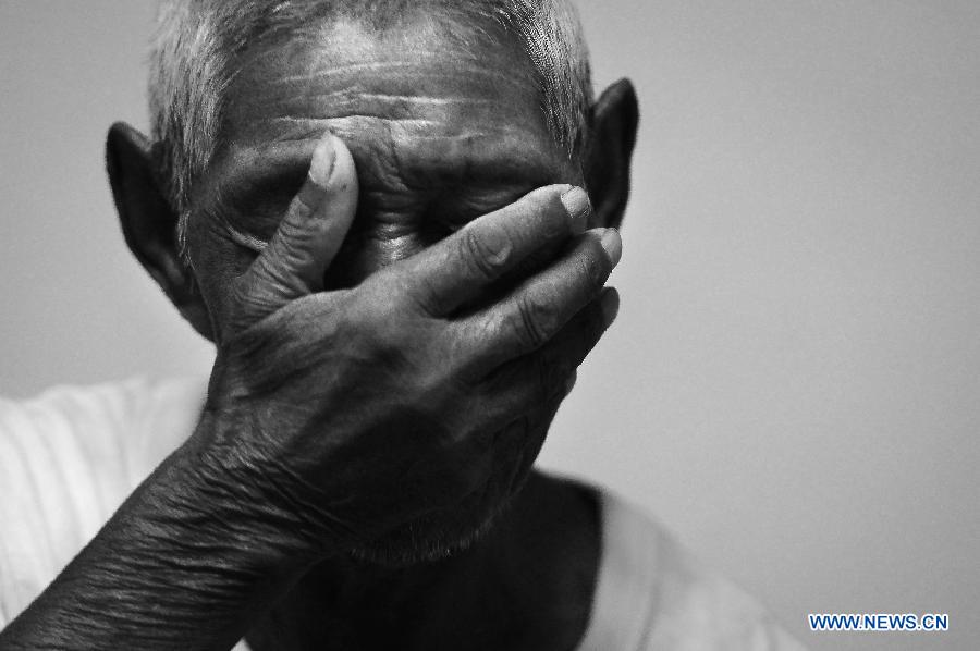 File photo taken on July 26, 2014 shows Chinese Sun Yuanqi weeping while recalling the tribulation as a forced labor working in Japan during World War II, in east China's Shandong Province. Japan invaded northeast China in 1931 and conducted a full-scale invasion in 1937. By the end of World War II, millions of Chinese forced laborers had been enslaved by Japanese invaders to toil under harsh conditions at mines and factories in northeast China and Japan. Those laborers were under close watch and suffered inhumane treatment. Many of them died from malnutrition, illness, physical abuse and plain murder. (Xinhua/Guo Xulei) 