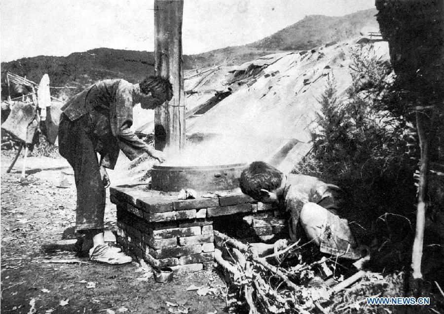 File photo copy shows Chinese forced labors cooking a meal, who were captured by Japanese to build the Fengman hydropower station in Jilin of northeast China after the region was illegally occupied by Japanese invaders in 1931. Japan invaded northeast China in 1931 and conducted a full-scale invasion in 1937. By the end of World War II, millions of Chinese forced laborers had been enslaved by Japanese invaders to toil under harsh conditions at mines and factories in northeast China and Japan. Those laborers were under close watch and suffered inhumane treatment. Many of them died from malnutrition, illness, physical abuse and plain murder. (Xinhua) 