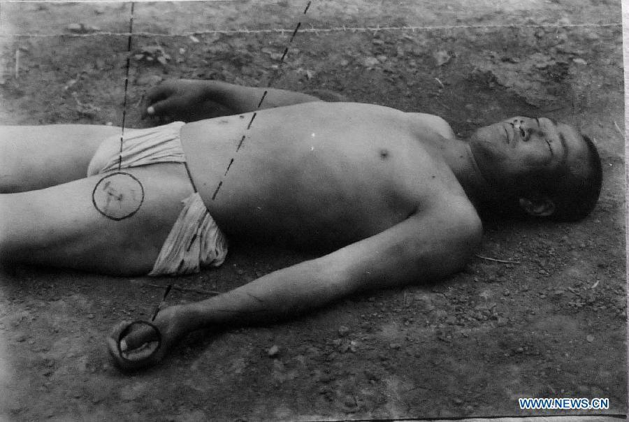 File photo copy taken on Jan. 10, 2014 from the provincial archives of Jilin shows a Chinese forced labor killed by electrocution during Japanese occupation of northeast China. Japan invaded northeast China in 1931 and conducted a full-scale invasion in 1937. By the end of World War II, millions of Chinese forced laborers had been enslaved by Japanese invaders to toil under harsh conditions at mines and factories in northeast China and Japan. Those laborers were under close watch and suffered inhumane treatment. Many of them died from malnutrition, illness, physical abuse and plain murder. (Xinhua/Wang Haofei) 