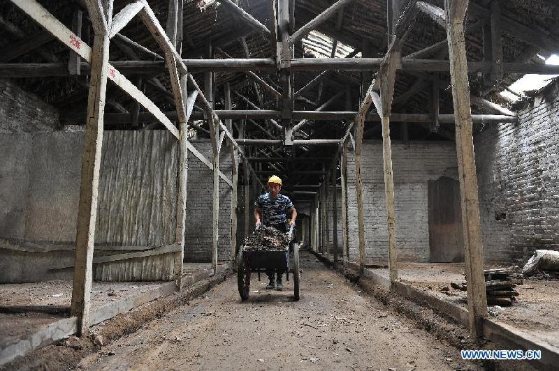 A worker clears rubbish at the site of a former concentration camp in Taiyuan, capital of north China's Shanxi Province, Aug. 3, 2015. A worker clears rubbish at the site of a former concentration camp in Taiyuan, capital of north China's Shanxi Province, Aug. 3, 2015.