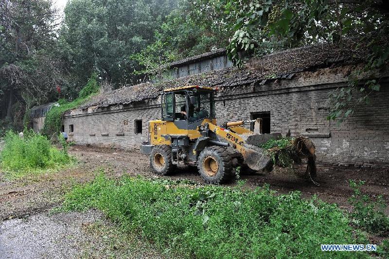 A machine works at the site of a former concentration camp in Taiyuan, capital of north China's Shanxi Province, Aug. 3, 2015.