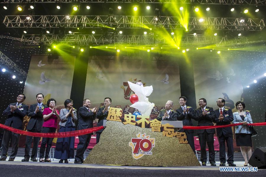 Tung Chee-hwa (5th R), vice chairman of the National Committee of the Chinese People's Political Consultative Conference, and Zhang Xiaoming (4th R), head of the Liaison Office of the Central People's Government in Hong Kong, attend a gala to mark the 70th anniversary of the victory of the Chinese people's war against Japanese aggression and the world's anti-Fascist war, in Hong Kong, south China, Aug. 12, 2015.