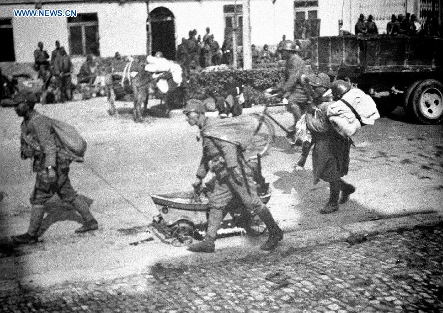File photo shows Japanese soldiers transfer looted goods by a plundered perambulator in Nanjing, east China's Jiangsu Province, Dec. 13, 1937.