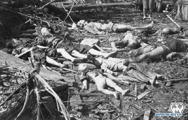 Undated file photo shows women and children killed in air-strikes by Japanese army in China. In the wartime of Japanese aggression to China during World War II, around 2.2 million Chinese children were killed or injured by Japanese invaders.