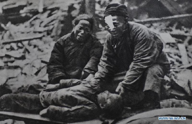 Undated file photo shows parents crying beside their child killed by Japanese soldiers in China. In the wartime of Japanese aggression to China during World War II, around 2.2 million Chinese children were killed or injured by Japanese invaders. 