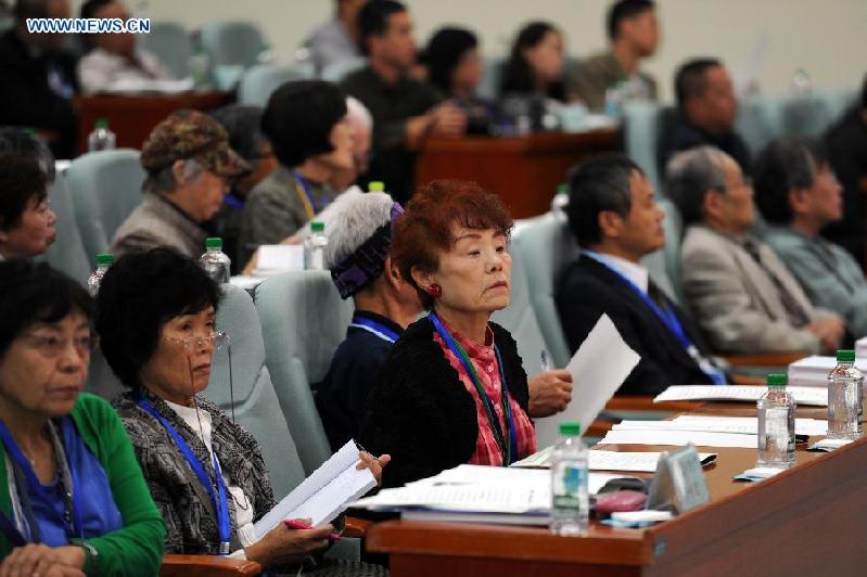 Delegates from Japan attend an international symposium on the war crime of Japanese Army Unit 731 in Harbin City, the seat of former headquarters of Unit 731, northeast China's Heilongjiang Province, Sept. 24, 2015.