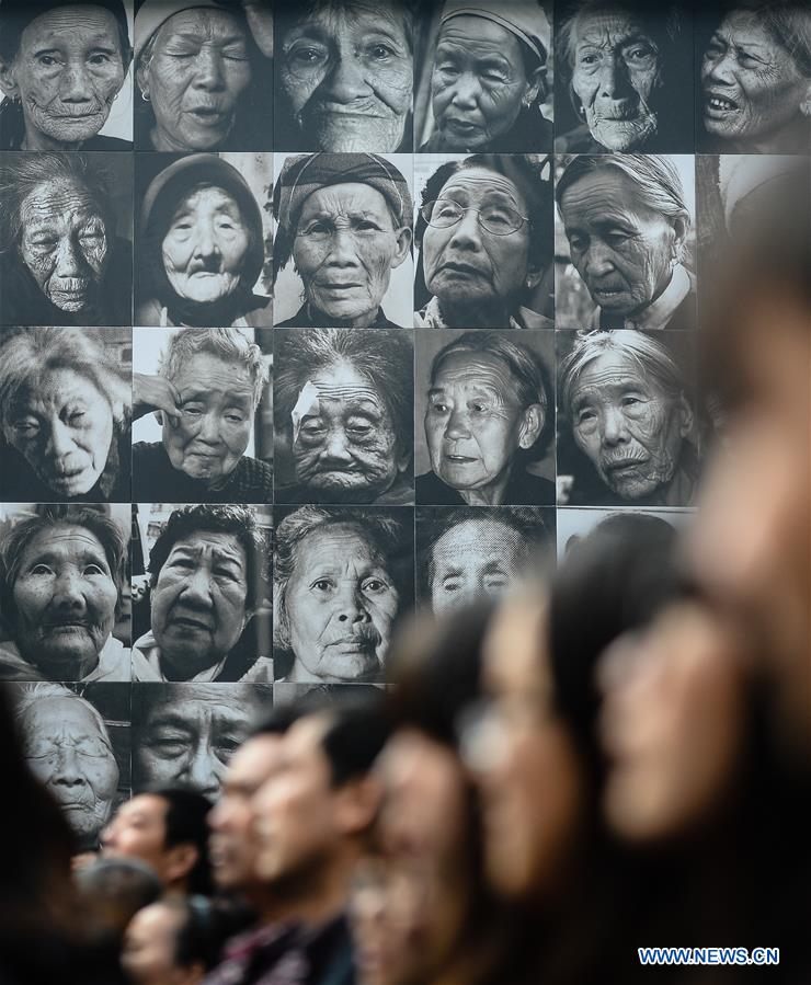 Visitors view the portraits of victims at the memorial for 'comfort women' in Nanjing, east China's Jiangsu Province, Dec. 1, 2015. 