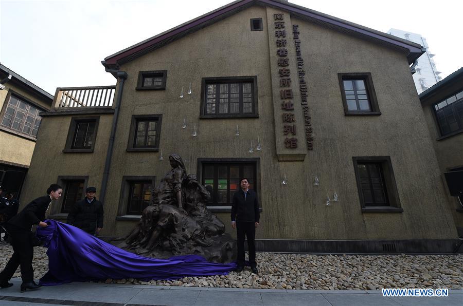 A sculpture is unveiled during the opening ceremony of the memorial for 'comfort women' in Nanjing, east China's Jiangsu Province, Dec. 1, 2015.