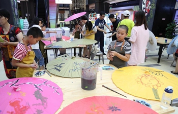 Children learn traditional intangible cultural heritages in E China