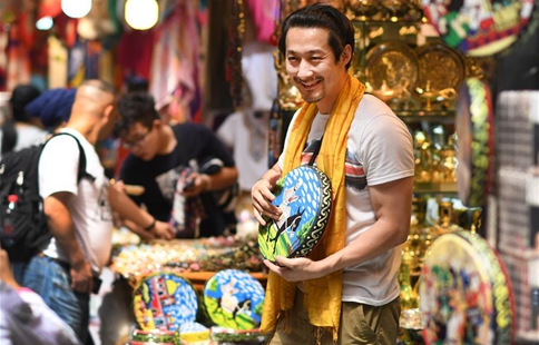 Tourists visit Int'l Bazar at Urumqi in NW China's Xinjiang